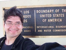 Herbert Midgley at the United States and Mexico international boundary sign